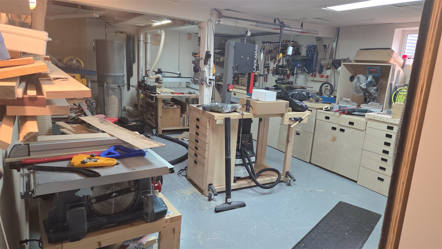 Inside the QCraft wood shop — workbenches, tools, and machines.